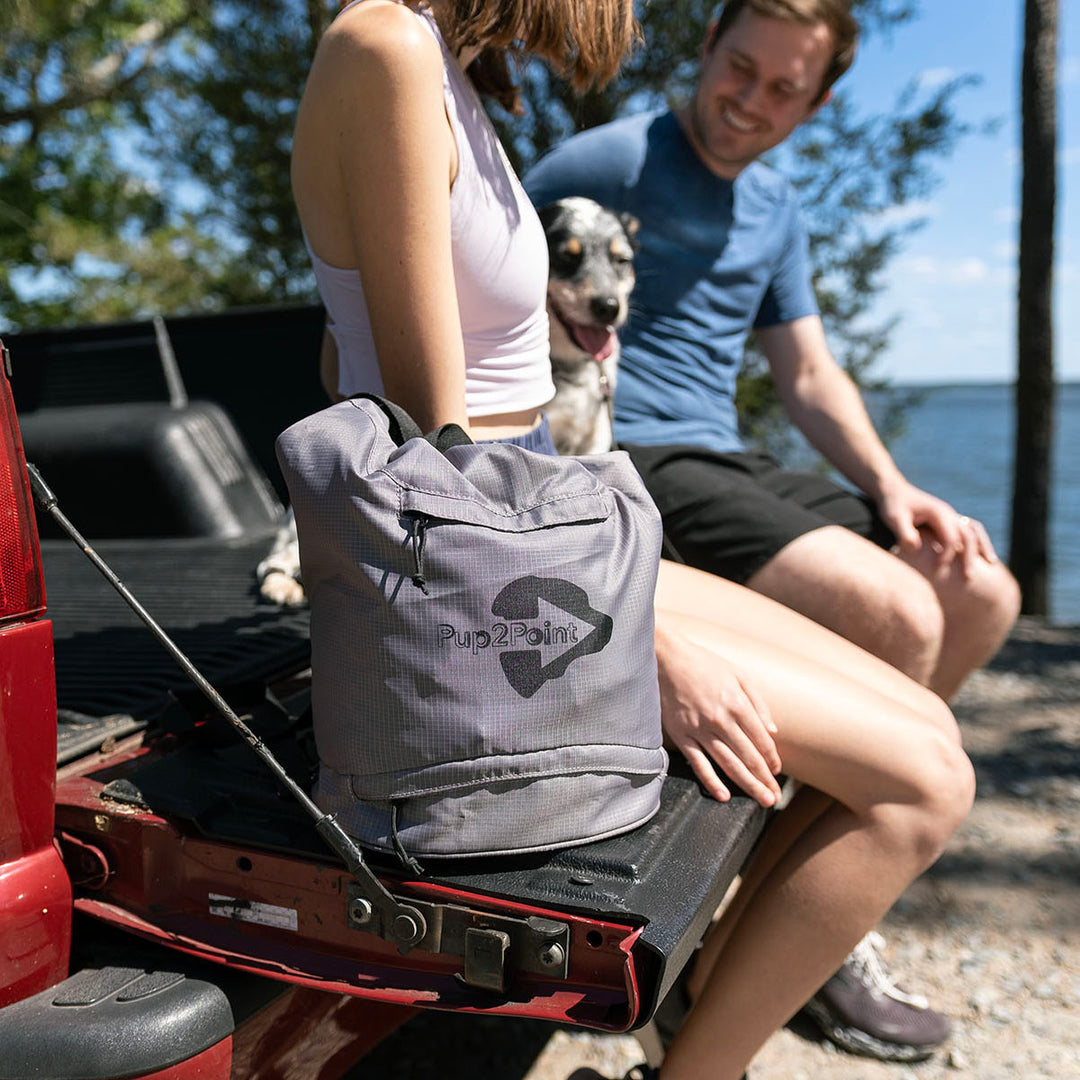 Gray travel dog bag with family on a vacation at the beach